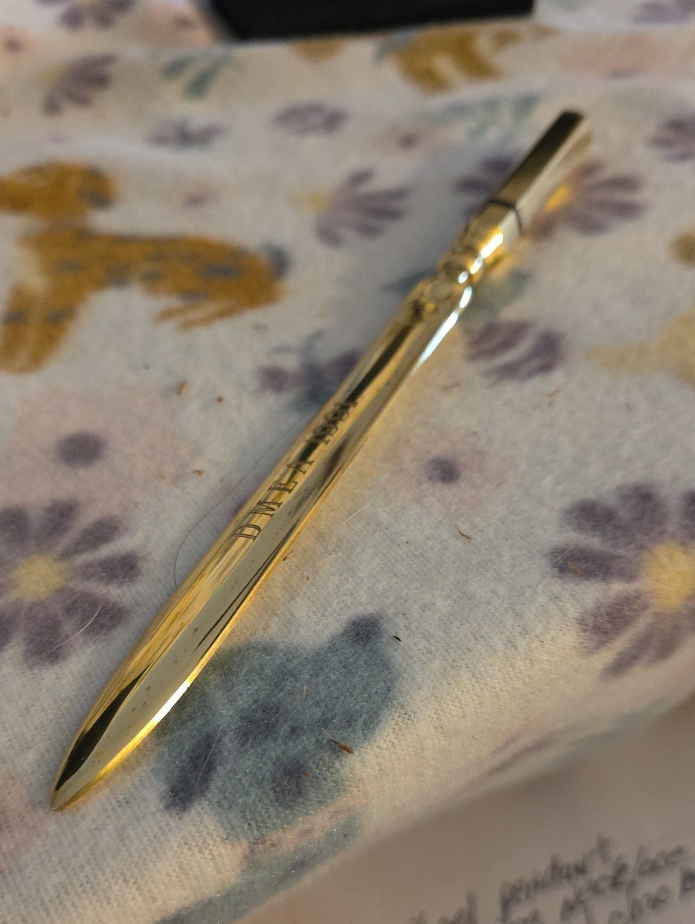 gold-tone metal letter opener inscribed with the text "DMEA 1991